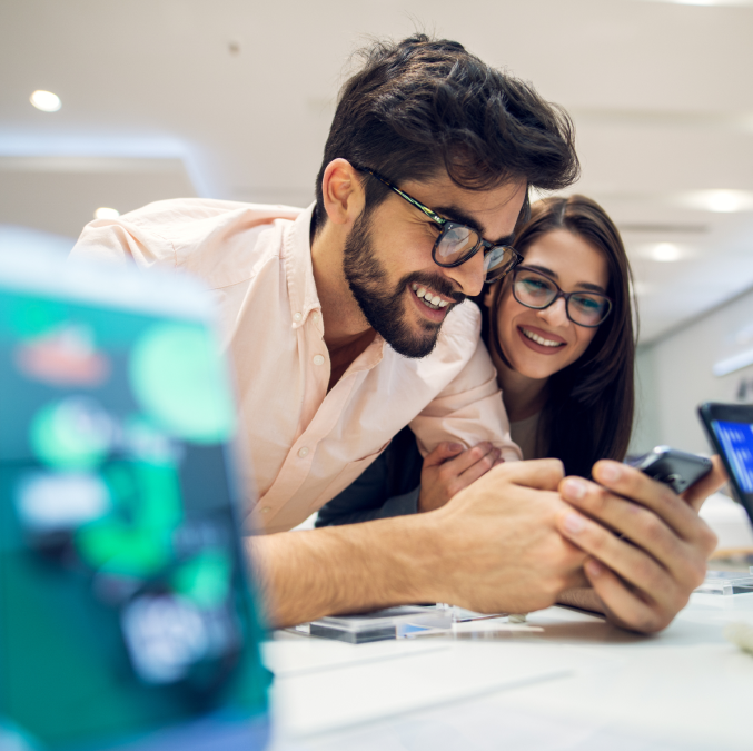 man and woman looking at phone smiling