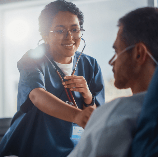 woman doctor listening to heartbeat of male patient