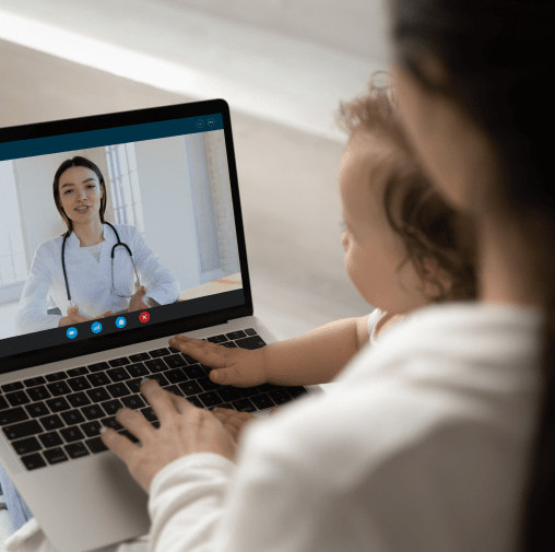 woman and baby having telehealth doctor appointment on laptop